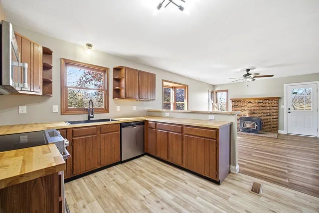 a view of a livingroom with wooden floor and a ceiling fan
