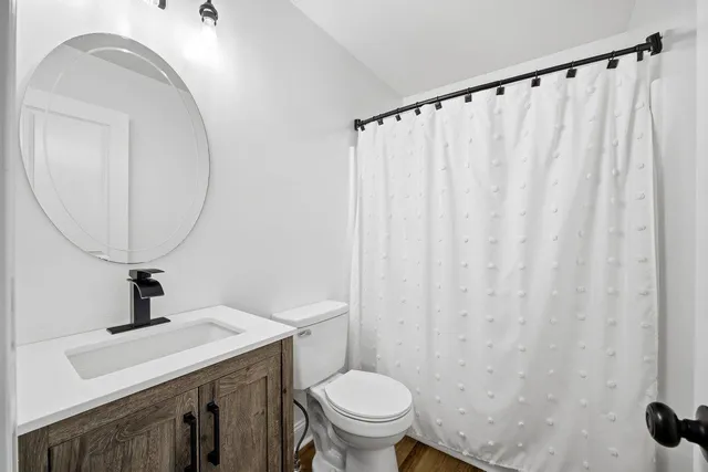 a view of a empty room with wooden floor