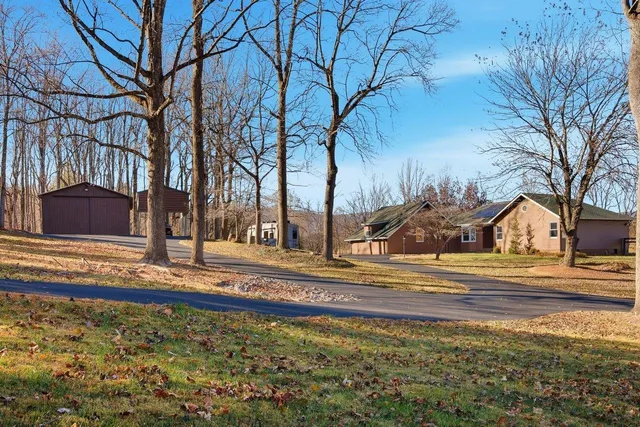 a view of a yard with yellow house