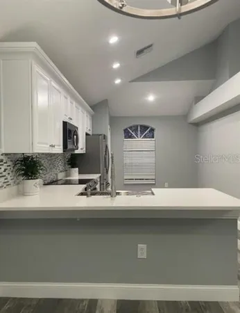 a view with counter top space with stainless steel appliances