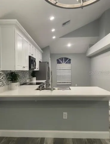 a view with counter top space with stainless steel appliances