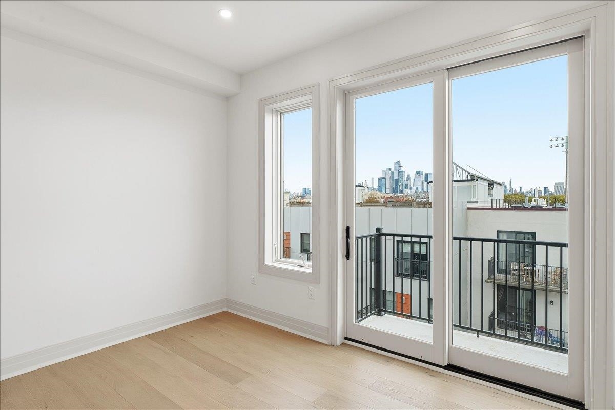 921 Madison Street, Unit 604 Hoboken, NJ 07030 - Photo 11 of 22 an empty room with windows
