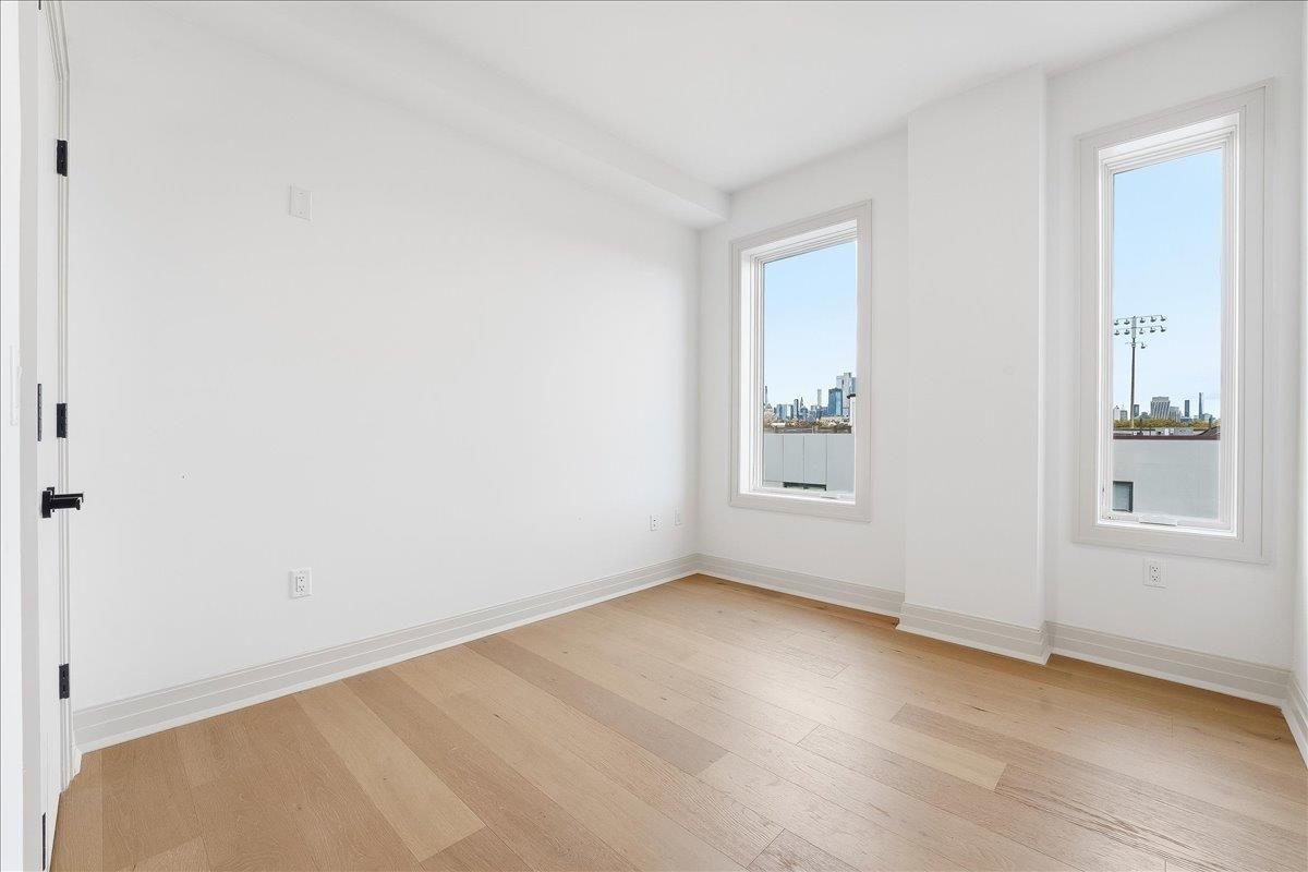 921 Madison Street, Unit 604 Hoboken, NJ 07030 - Photo 13 of 22 an empty room with windows