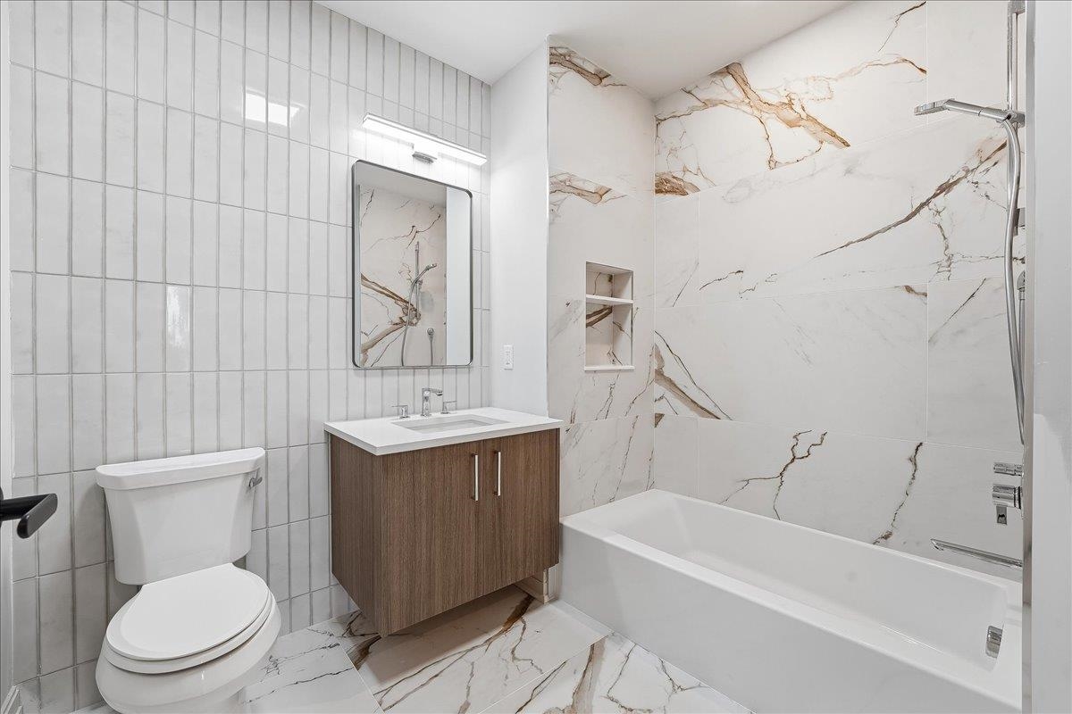 921 Madison Street, Unit 604 Hoboken, NJ 07030 - Photo 14 of 22 a bathroom with a sink a toilet and shower