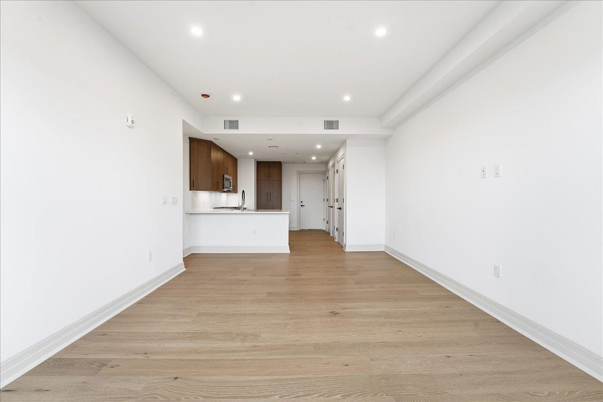 921 Madison Street, Unit 604 Hoboken, NJ 07030 - Photo 9 of 22 an empty room with wooden floor and windows