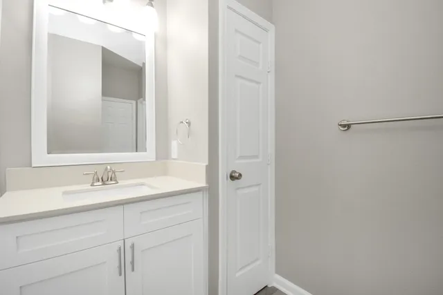 a kitchen with stainless steel appliances granite countertop a kitchen island hardwood floor sink stove dining table and chairs