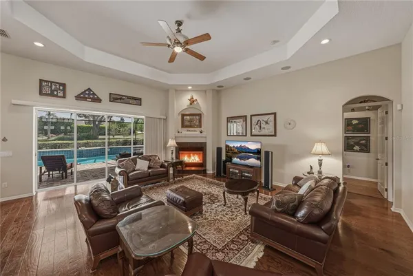 a living room with furniture and a dining table with wooden floor