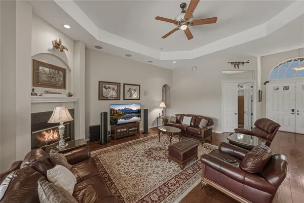 a living room with furniture a fireplace and a flat screen tv