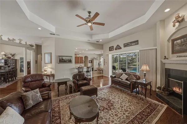 a kitchen with stainless steel appliances kitchen island granite countertop a table chairs sink and cabinets