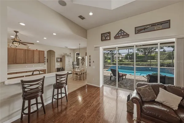 a large kitchen with stainless steel appliances a sink dishwasher stove refrigerator and cabinets