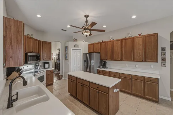 a kitchen with a sink stove and microwave
