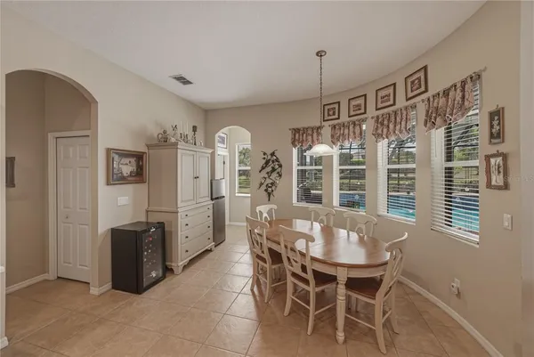 a view of a dining room with furniture and chandelier