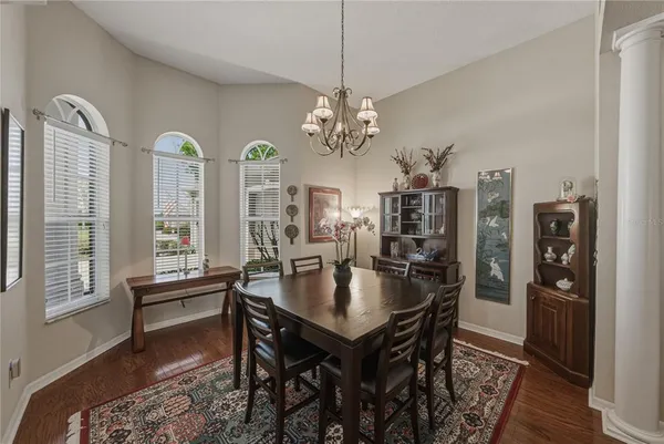 a living room with furniture a ceiling fan and a window