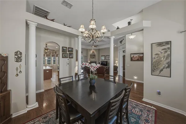 a bedroom with two beds and wooden floor