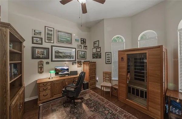 a large bedroom with a bed and wooden floor