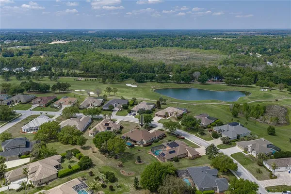 an aerial view of a houses with outdoor space and lake view