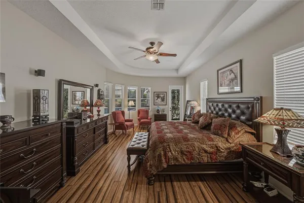 a bedroom with a bed and a chandelier