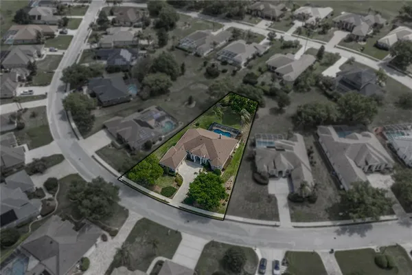 an aerial view of a house with a yard