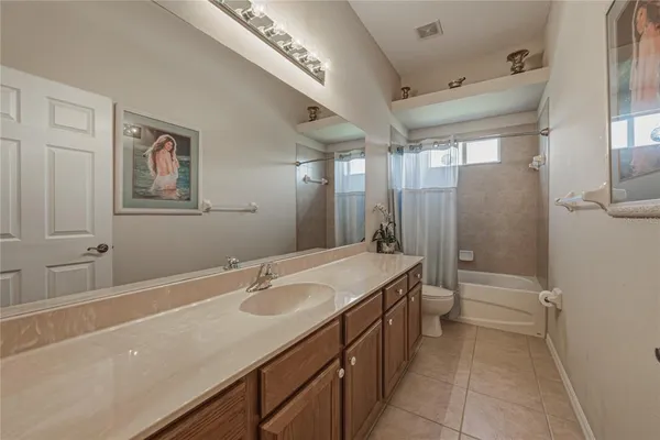 a view of a building with a bench and potted plants