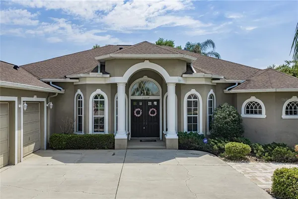 a living room with furniture ceiling fan and a window