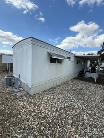 a living room with furniture a window and wooden floor