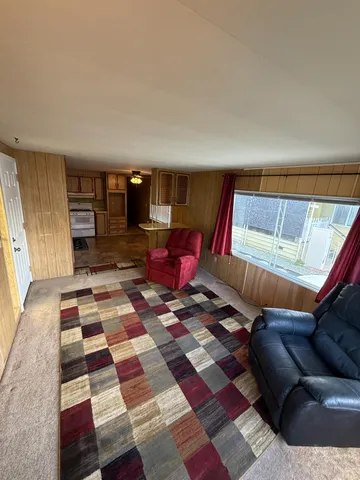 a living room with a rug and a couch