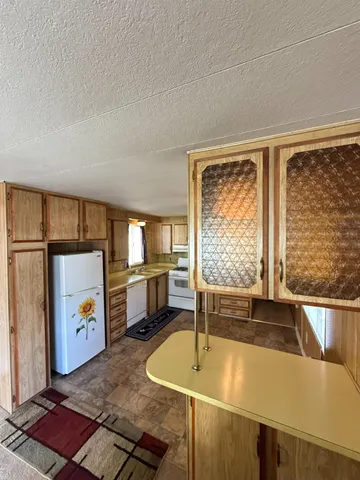 a living room with a table and a fireplace