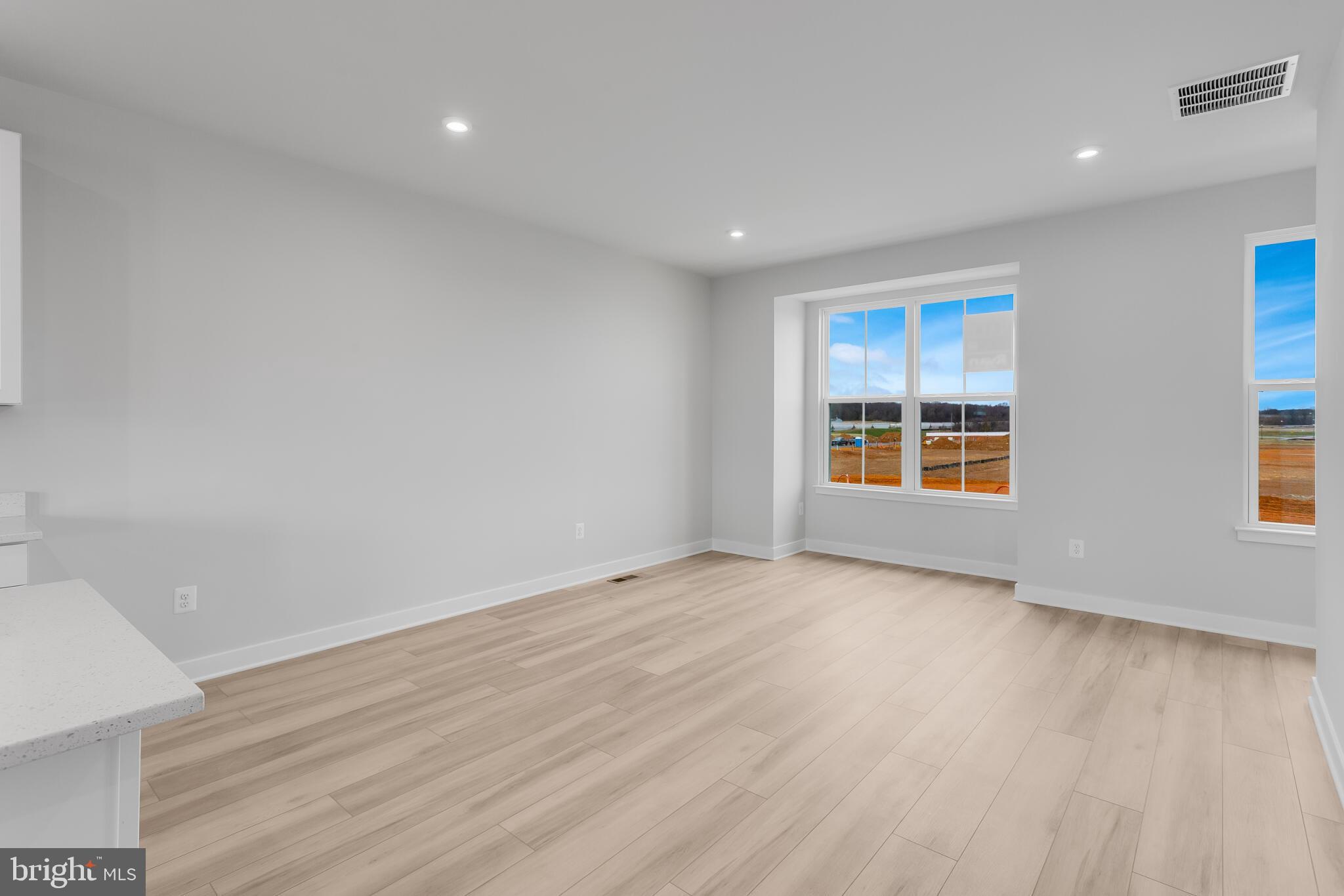 1729 Destrier Street Ranson, WV 25438 - Photo 4 of 16 a view of an empty room with wooden floor and a window