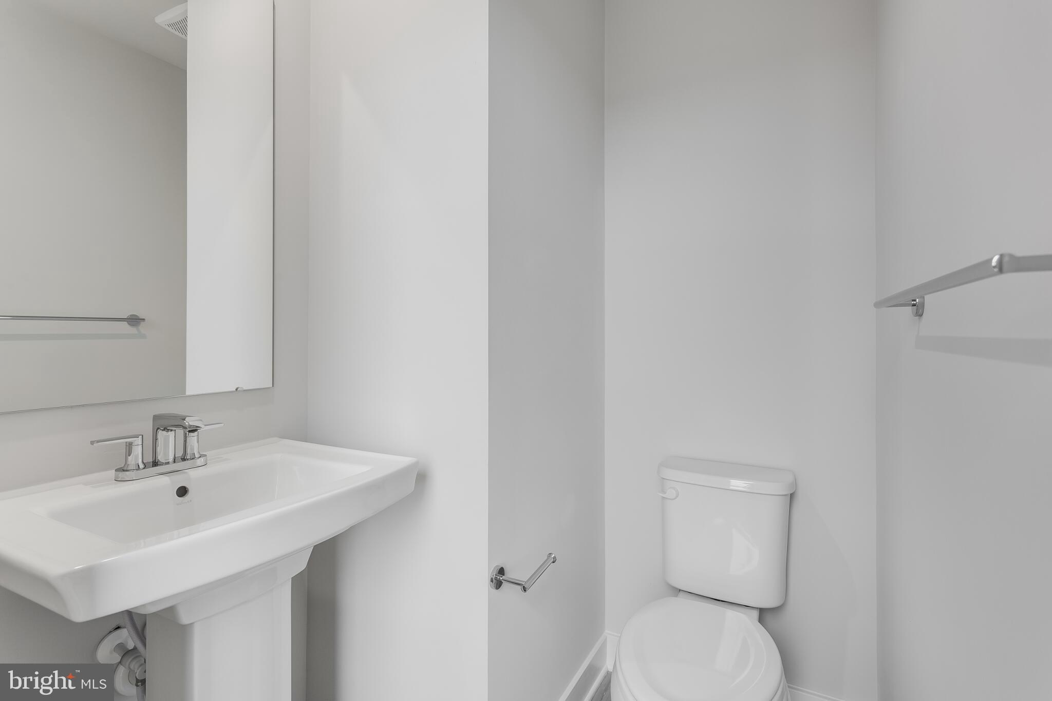 1729 Destrier Street Ranson, WV 25438 - Photo 7 of 16 a bathroom with a sink a toilet and a mirror