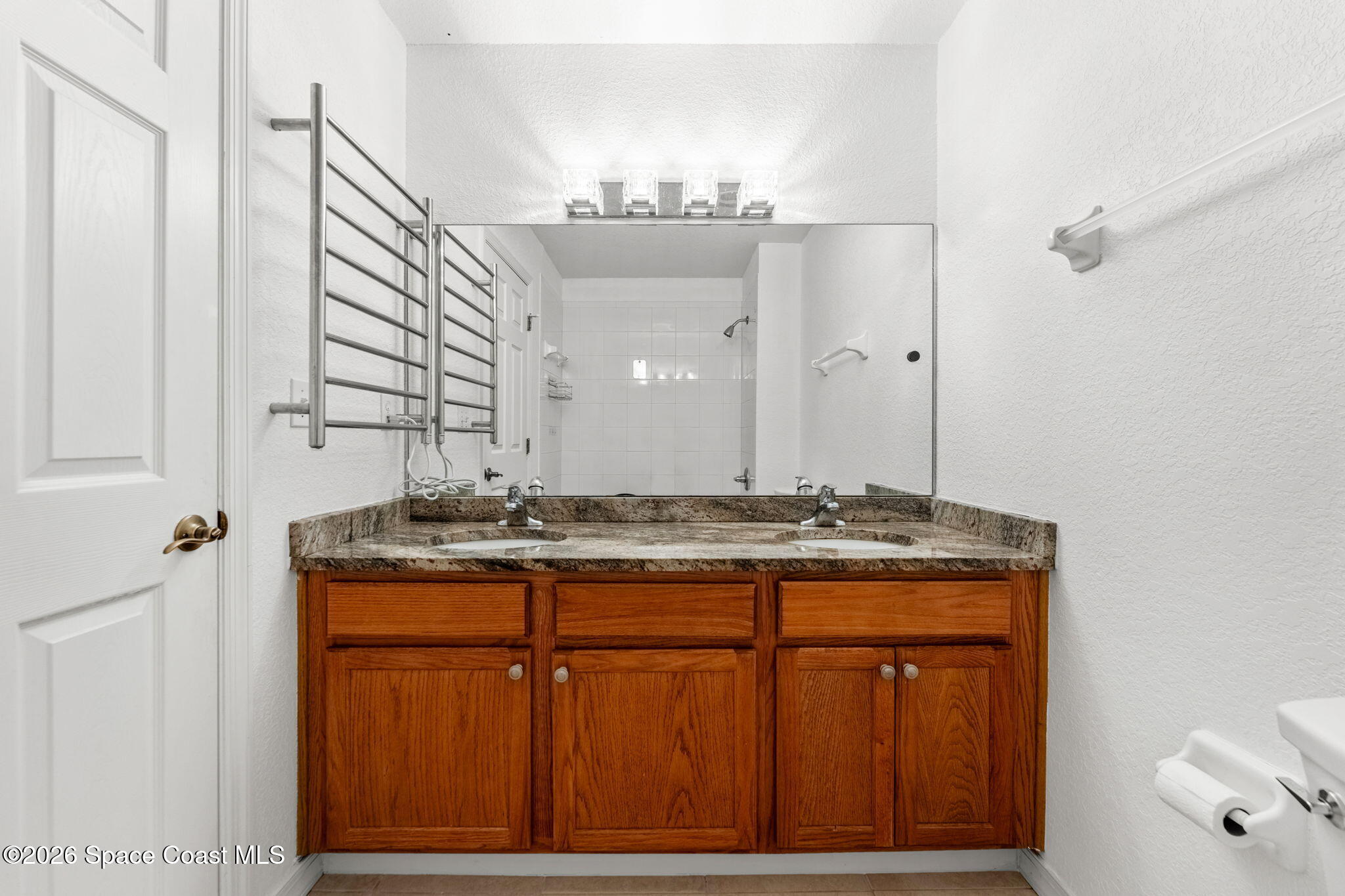110 Turpial Way, Unit 106 Melbourne, FL 32901 - Photo 35 of 50 a bathroom with a granite countertop sink a mirror and a shower