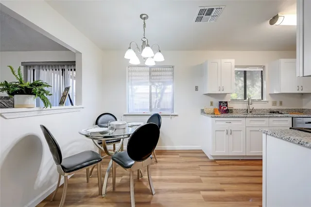 a kitchen with a table chairs stove and microwave