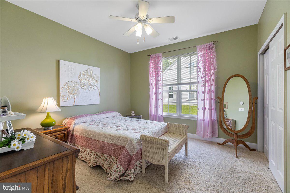 10 Fitzgerald Lane Columbus, NJ 08022 - Photo 17 of 33 a bedroom with a bed a chandelier and dresser