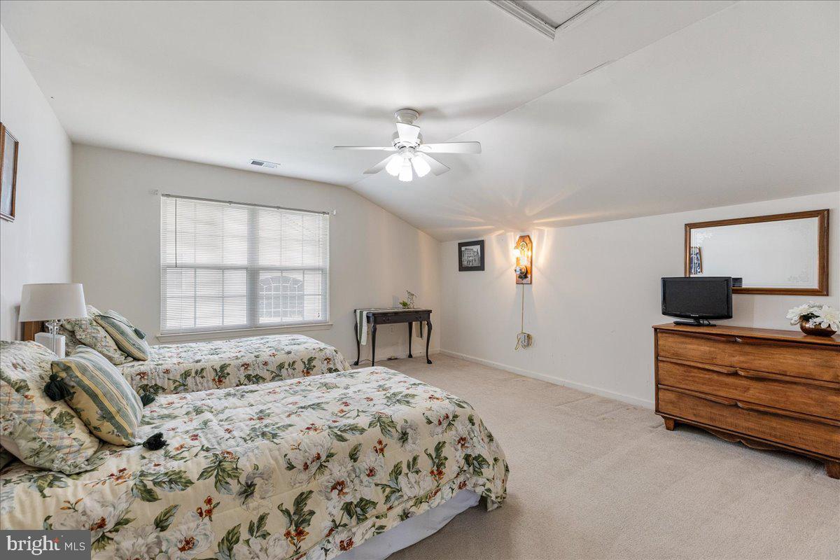 10 Fitzgerald Lane Columbus, NJ 08022 - Photo 25 of 33 a bedroom with a bed and a chandelier