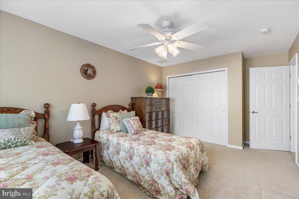 10 Fitzgerald Lane Columbus, NJ 08022 - Photo 28 of 33 a bedroom with two beds and a chandelier