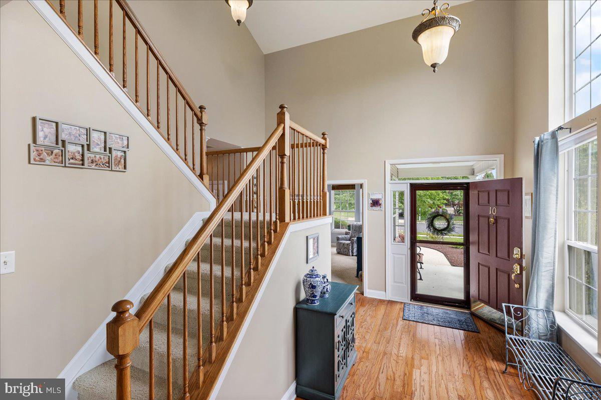 10 Fitzgerald Lane Columbus, NJ 08022 - Photo 3 of 33 a view of staircase with lots of frames on wall and wooden floor