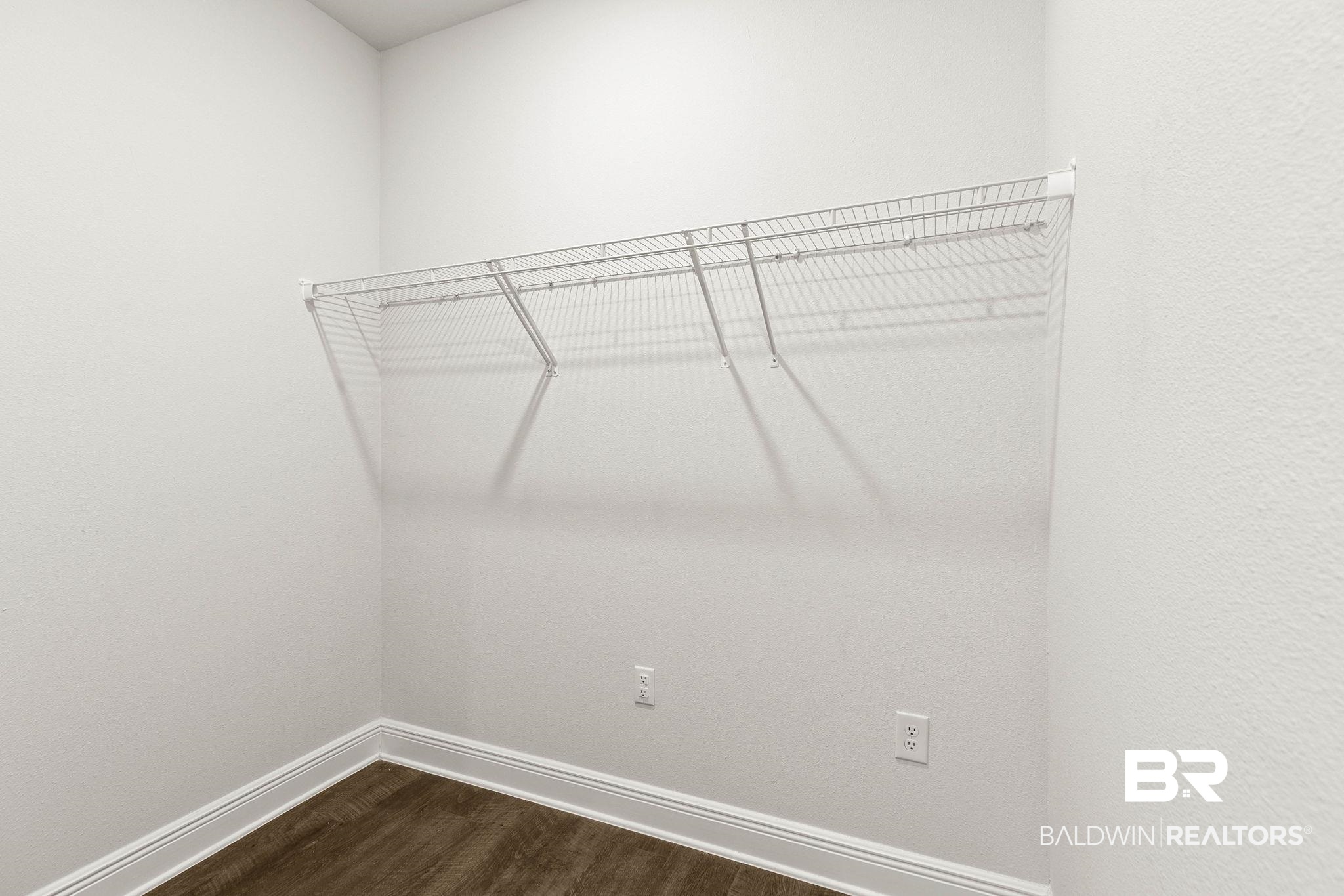 9448 Amethyst Drive Daphne, AL 36526 - Photo 47 of 61 Walk in closet with dark wood-style floors