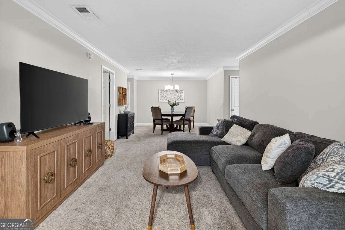 2514 Demere Road, Unit 7 St. Simons, GA 31522 - Photo 13 of 22 a living room with furniture and a flat screen tv