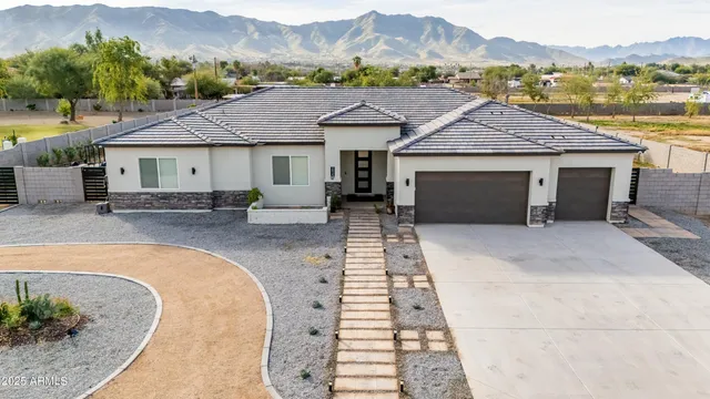 a front view of a house with a yard and a garage