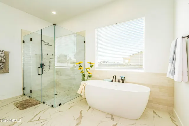 a view of a bedroom with a bed and a window