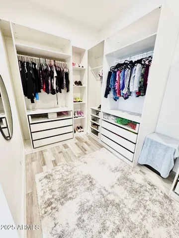 a bedroom with bed and a baby crib