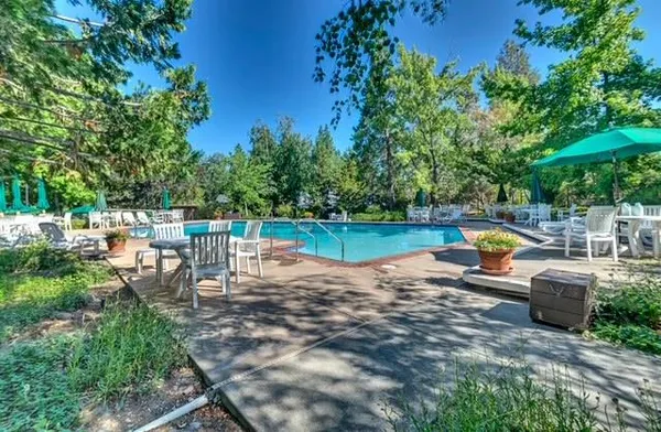 a view of a field with trees in the background
