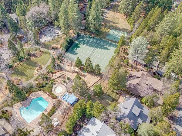 a view of a swimming pool with a yard and sitting area