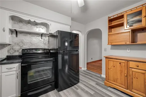 a kitchen with stainless steel appliances granite countertop a refrigerator and a stove top oven