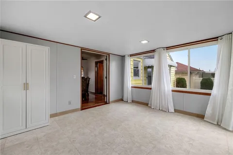 an empty room with window and furniture