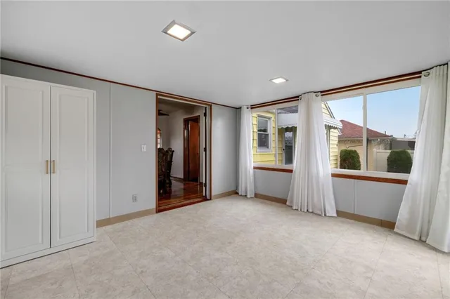 an empty room with window and furniture