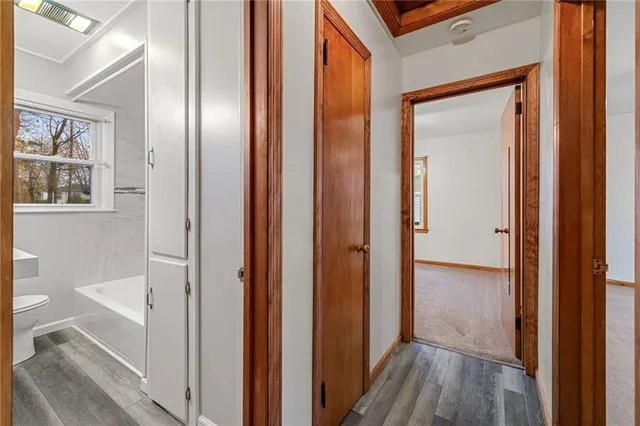 a view of a hallway with wooden floor