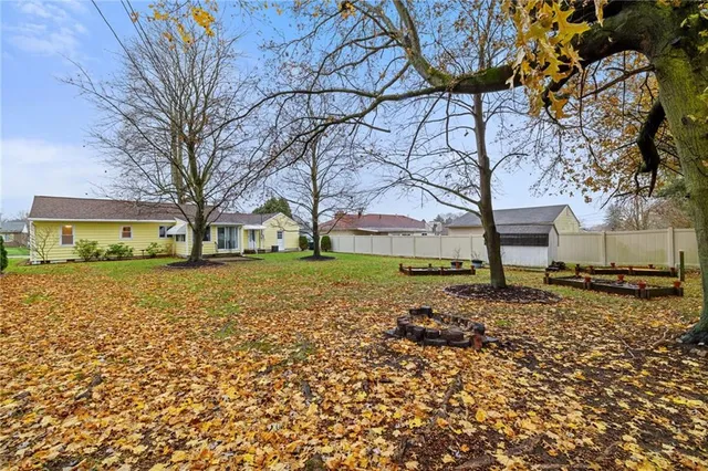 a view of a yard with a house and a tree