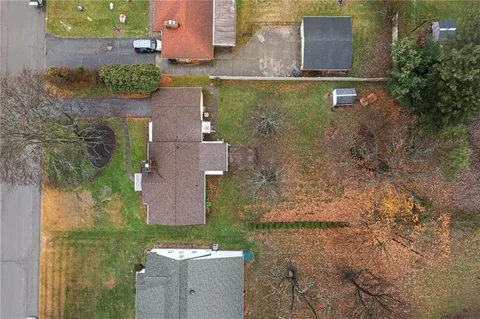 an aerial view of a house with a yard