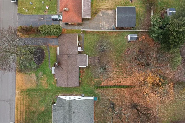 an aerial view of a house with a yard