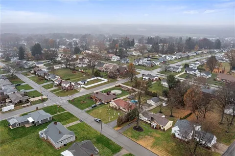 an aerial view of residential building with green space